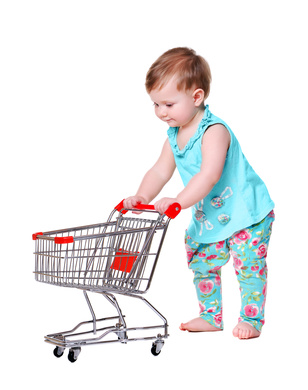 baby girl pushing shopping trolley