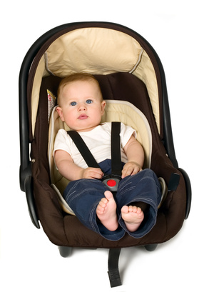 Baby boy is sitting in safety car seat